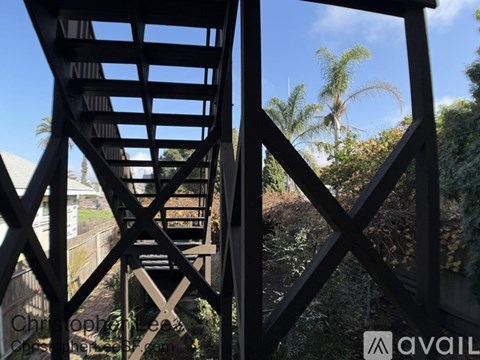 A black metal gate with a cross design in the middle.