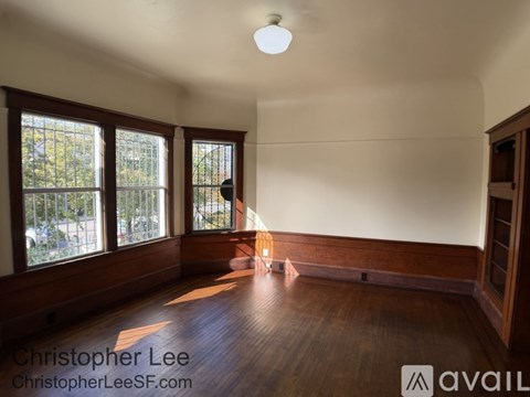 A room with wooden floors and a large window.