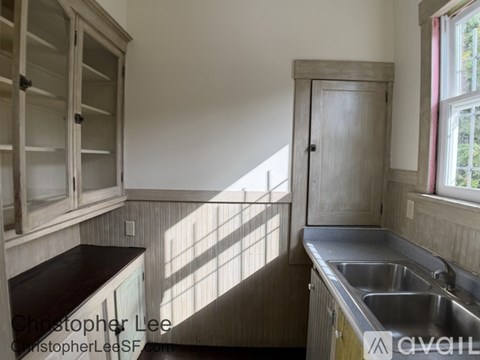 A kitchen with wooden cabinets and a window.