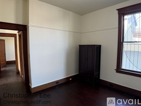A room with white walls and a brown floor.