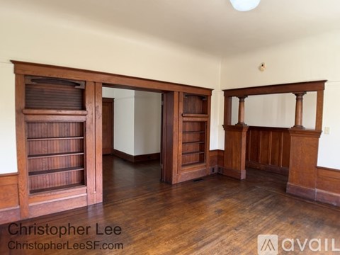 A room with wooden floors and furniture.