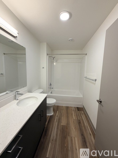 A bathroom with a sink, toilet, and bathtub.