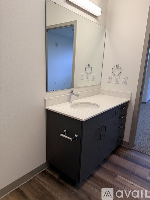 A bathroom with a sink and mirror.