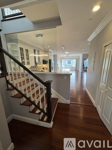 A hallway with a staircase leading to the second floor.
