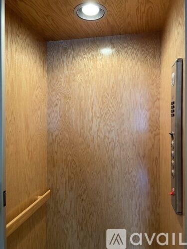 A wooden elevator with a control panel on the right side.