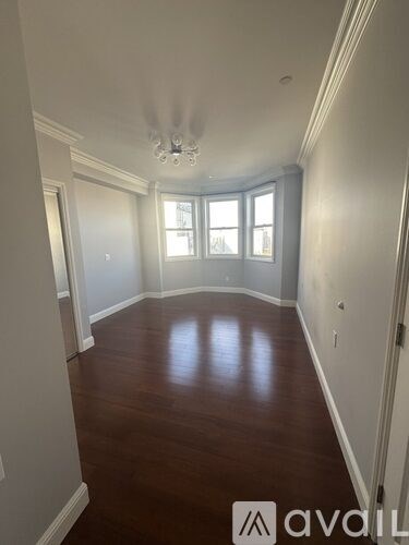 A room with wooden floors and a chandelier.