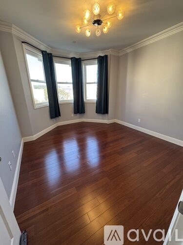 A room with wooden floors and a chandelier.