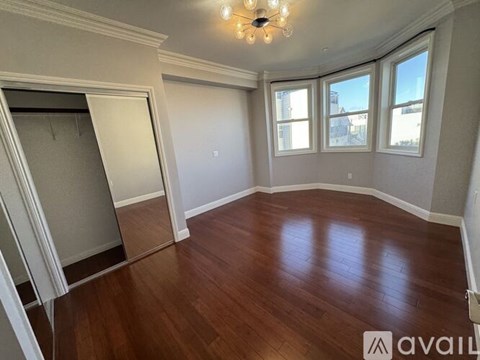 A room with wooden floors and a chandelier.