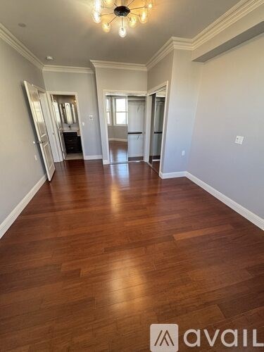 A room with wooden floors and a chandelier.