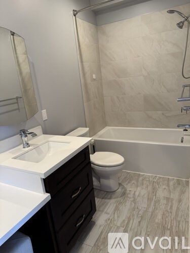 A bathroom with a sink, toilet, and bathtub.