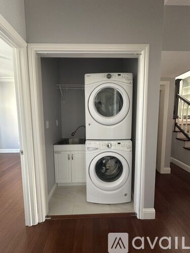 A white washer and dryer in a small laundry room.