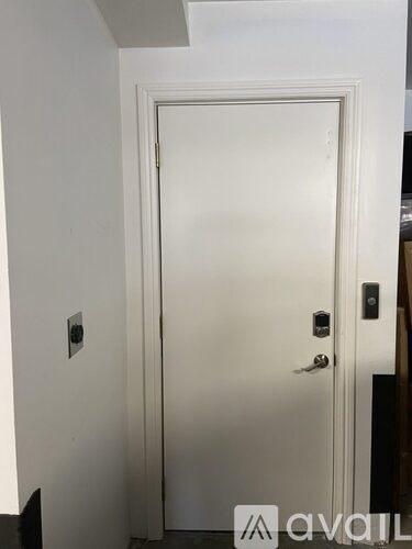 A white door with a handle and a lock.