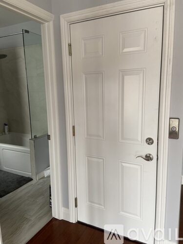 A white door with a glass panel on the left side.