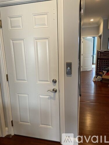 A white door with a silver handle and a lock.