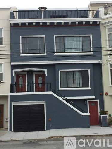 A two-story house with a balcony on the second floor.