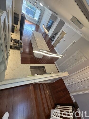 A modern kitchen with wooden cabinets and a white countertop.