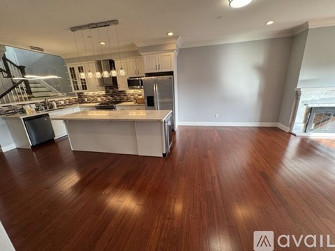 A spacious kitchen with wooden floors and a large island.