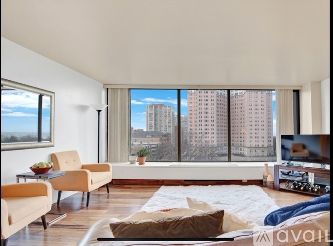 A living room with a view of a city skyline.