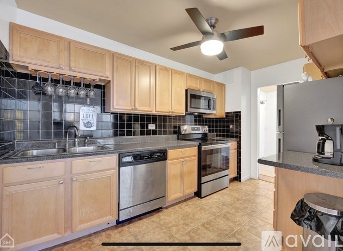 A kitchen with wooden cabinets and stainless steel appliances.