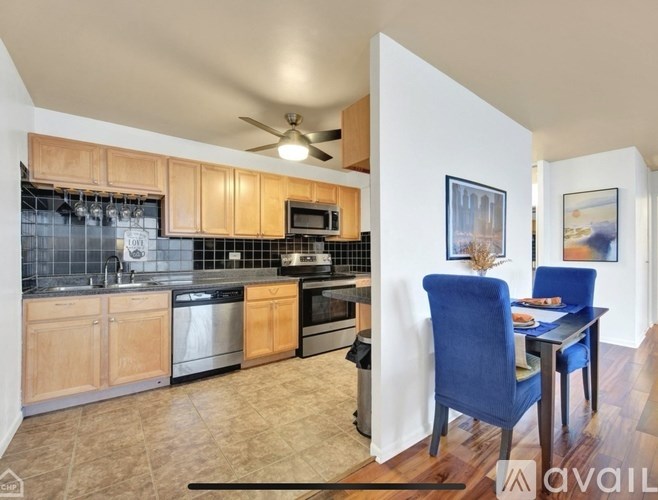 A kitchen with wooden cabinets and a dining table with chairs.