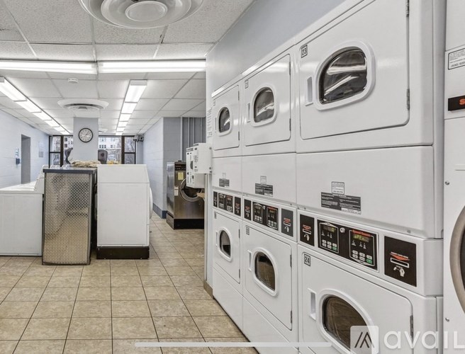 A row of washing machines in a laundromat.
