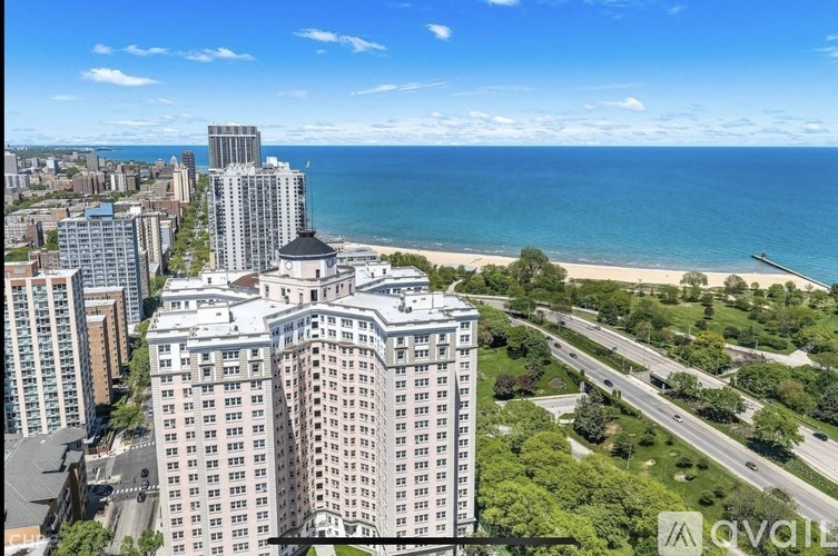 A beachfront city with a large building in the foreground.