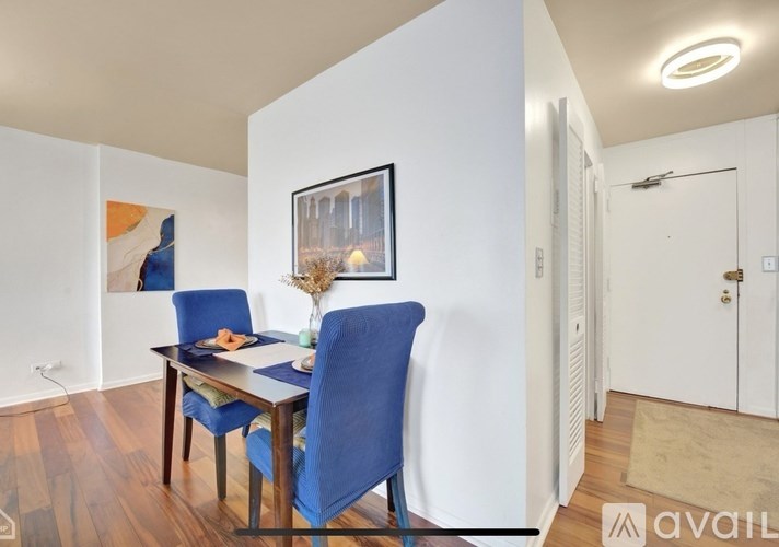 A dining room with a table and chairs.
