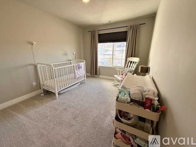 A baby room with a crib and a rocking chair.