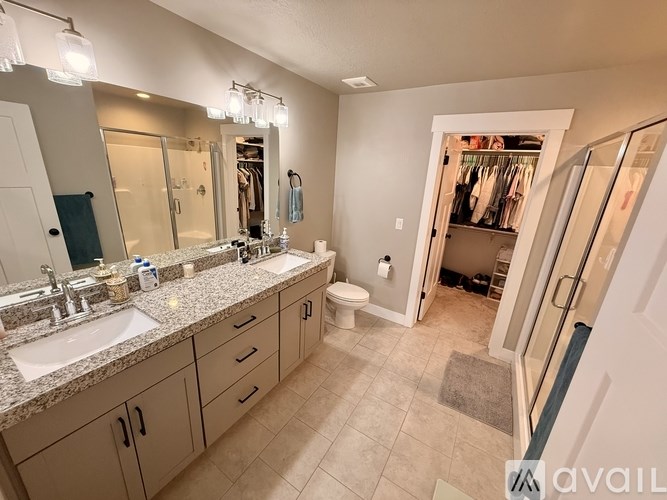 A bathroom with a sink, mirror, and toilet.