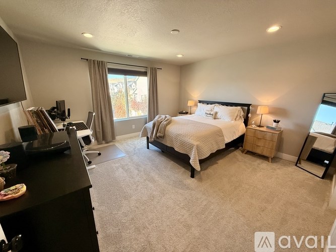 A bedroom with a large bed and a flat screen TV.