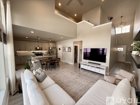 A modern living room with a large white sofa and a television.