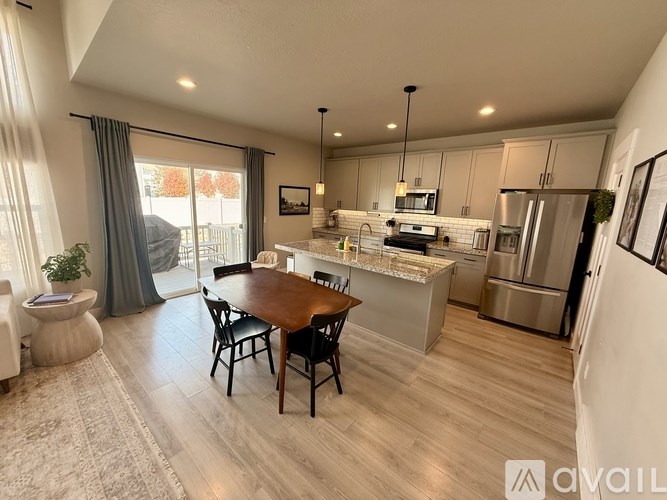 A modern kitchen with a dining table and chairs.