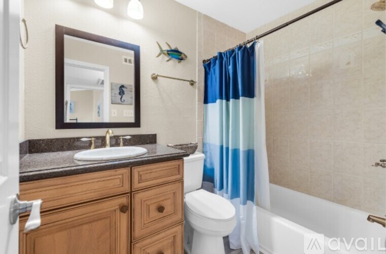 A bathroom with a wooden vanity and a white toilet.