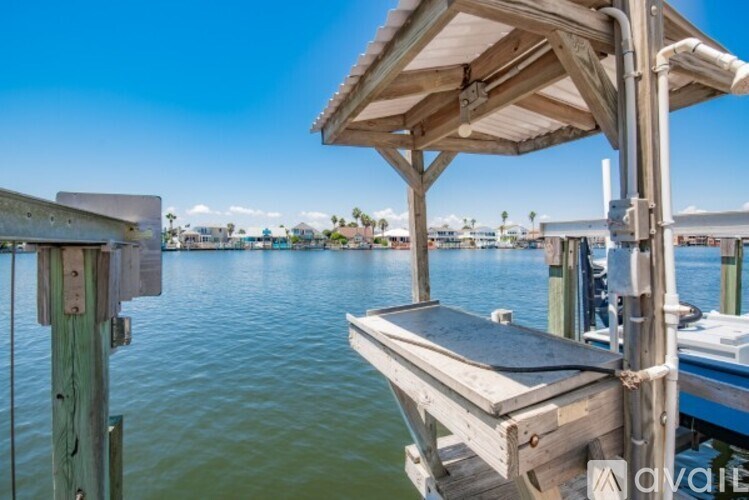 A wooden dock extends into a calm body of water.