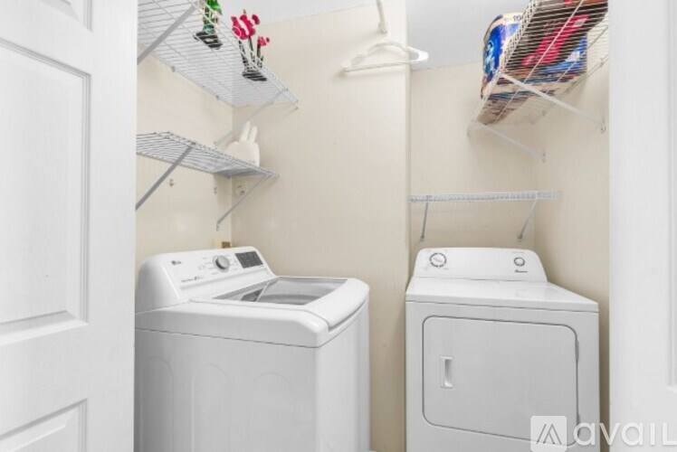 A small laundry room with a washer and dryer.