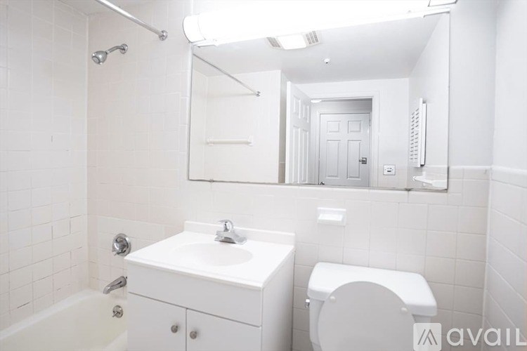 A white bathroom with a sink, toilet, and bathtub.