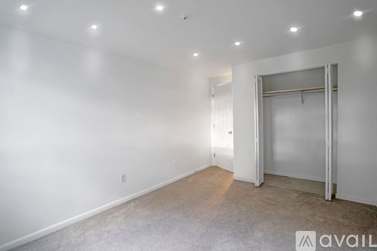 A room with a sliding door and a carpeted floor.