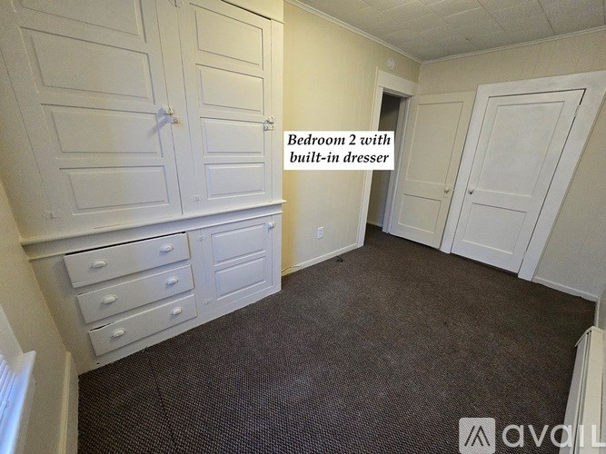 Bedroom 2 with built-in dresser.