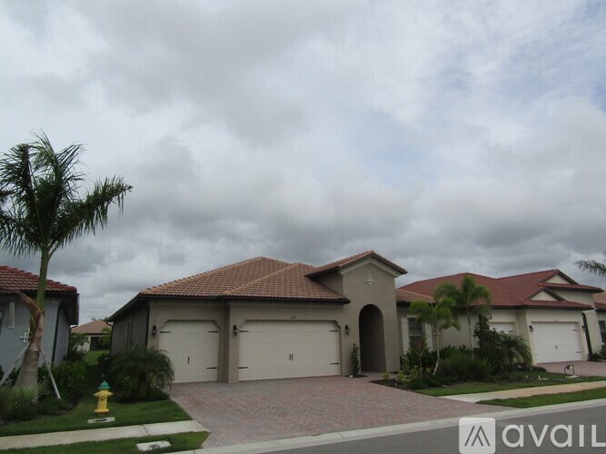 A house with a driveway and a fire hydrant in front.
