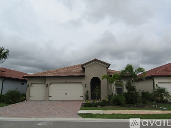 A house with a red roof and a garage door.