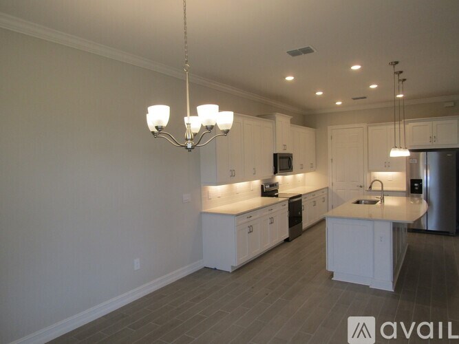 A modern kitchen with white cabinets and a central island.