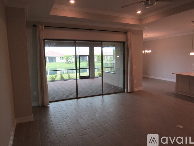 A room with a tiled floor and a sliding glass door leading to a backyard.