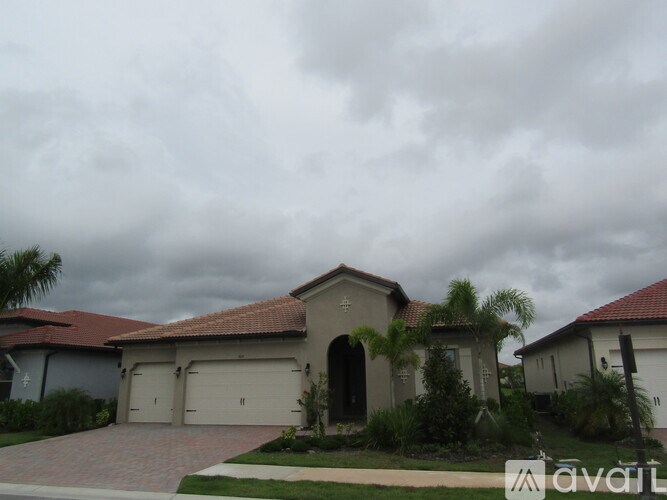A house with a red roof and a garage door is for sale.