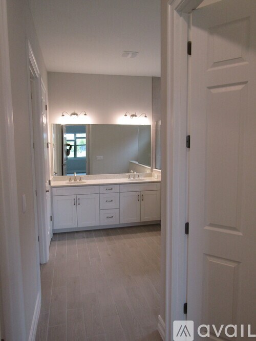 A bathroom with a vanity and a mirror.