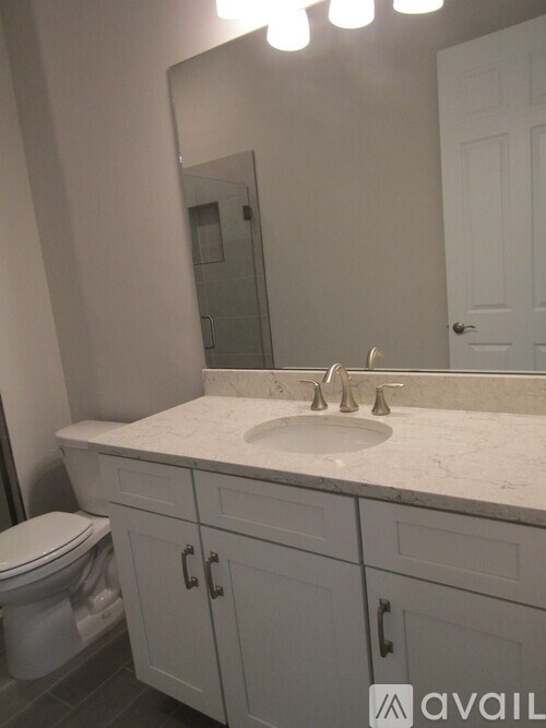 A bathroom with a white toilet and sink.