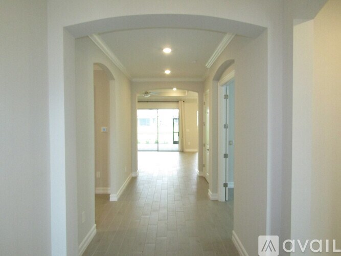 A long hallway with tiled floors and white walls.