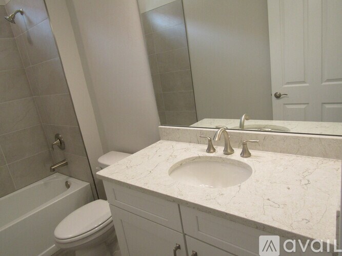 A bathroom with a marble countertop and a white toilet.