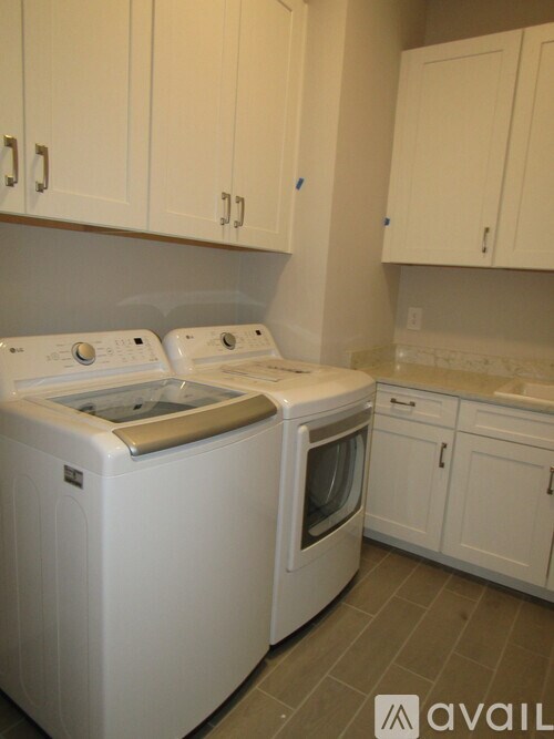 A white washing machine and dryer in a kitchen.