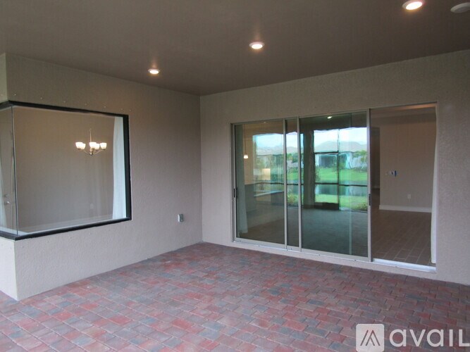A room with a tiled floor and a glass door.