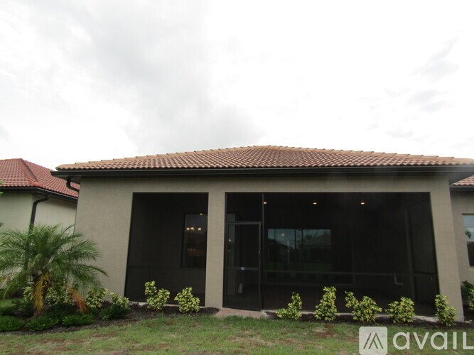 A house with a red roof and a sign that says "available" in front of it.